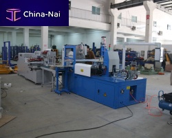 Automatic shrink wrapping machine for cable coilswith shrink tunnel