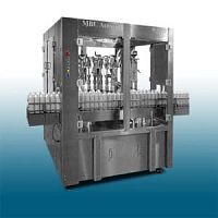 Aerosol spray filling machine with rotary indexing table