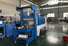 Semi-automatic shrink wrapping machine for bottles